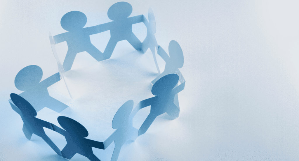 10 paper cut out figures holding hands