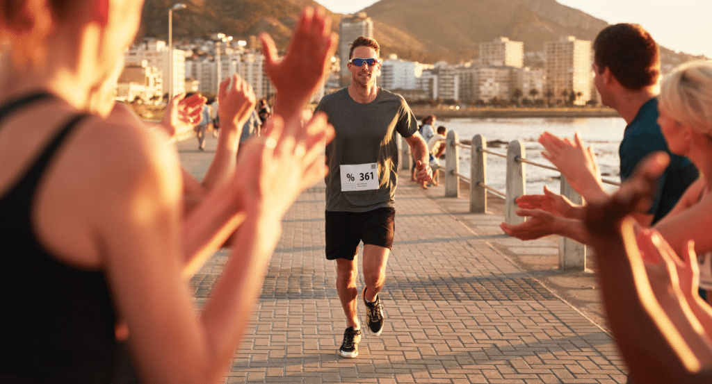 Marathon man finishing the race and crossing the finish line